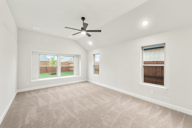 unfurnished room featuring ceiling fan, light carpet, and vaulted ceiling