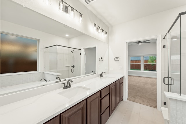 bathroom with tile patterned floors, ceiling fan, an enclosed shower, and vanity