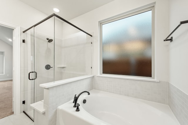 bathroom with shower with separate bathtub and tile patterned floors