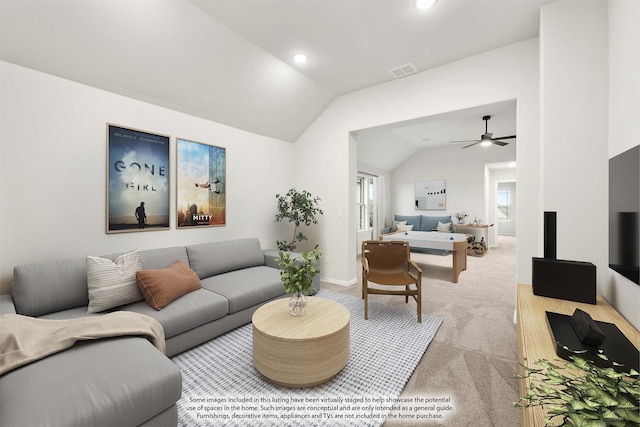 carpeted living room with vaulted ceiling and ceiling fan