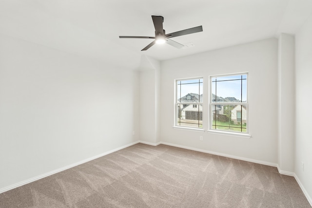 carpeted spare room featuring ceiling fan