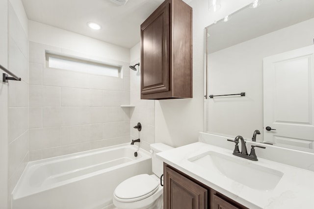 full bathroom featuring toilet, tiled shower / bath combo, and vanity