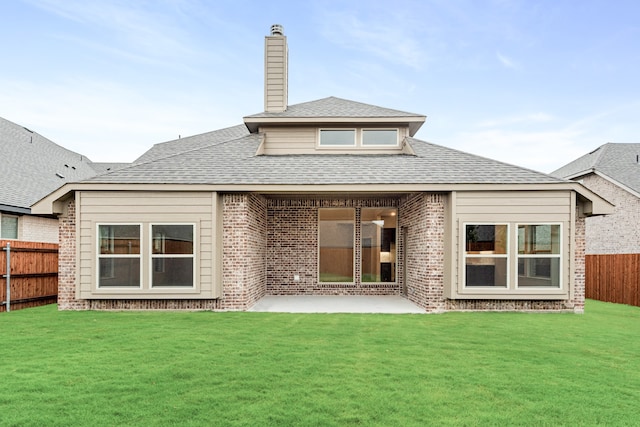 back of house featuring a yard and a patio area