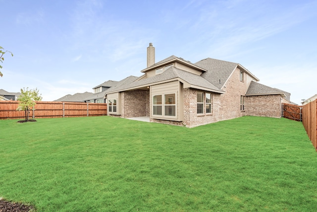 back of property featuring a lawn and a patio area