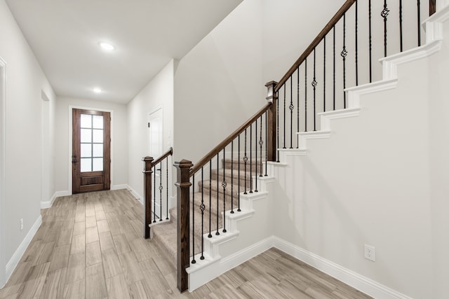 foyer entrance with light hardwood / wood-style floors