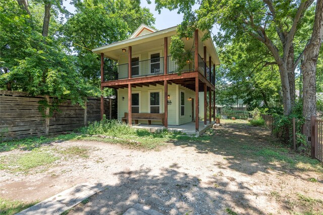 back of property with a patio area and a balcony