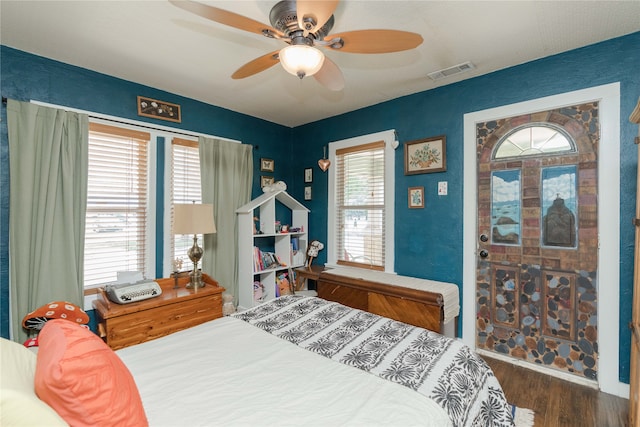 bedroom with dark wood-type flooring, ceiling fan, and multiple windows