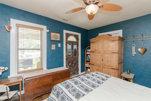 bedroom with wood-type flooring and ceiling fan