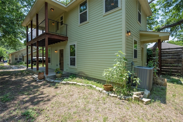 view of home's exterior with central AC and a balcony