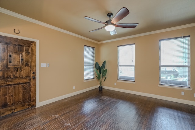 empty room featuring dark wood-type flooring, ornamental molding, and ceiling fan