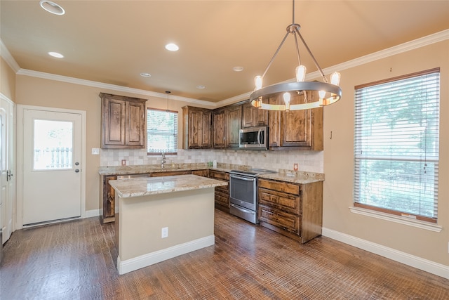 kitchen with a wealth of natural light, backsplash, and stainless steel appliances