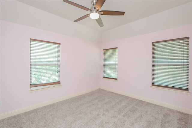 carpeted spare room with ceiling fan