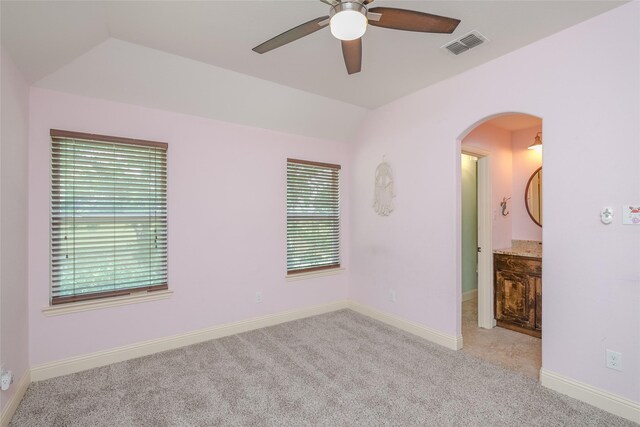 spare room featuring ceiling fan and light carpet