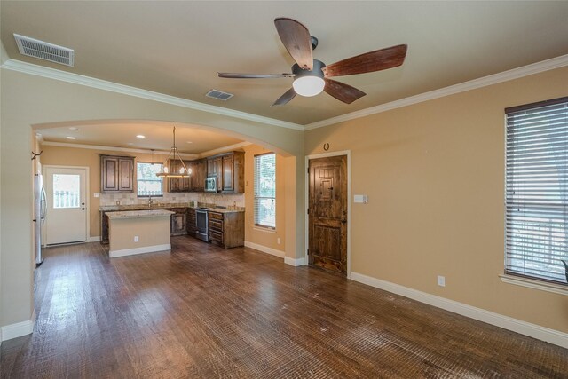 unfurnished living room featuring ceiling fan with notable chandelier, ornamental molding, and dark hardwood / wood-style flooring