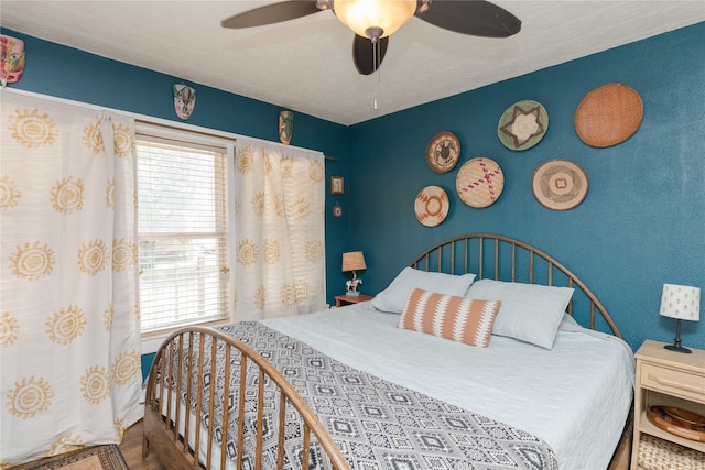 bedroom featuring wood-type flooring and ceiling fan