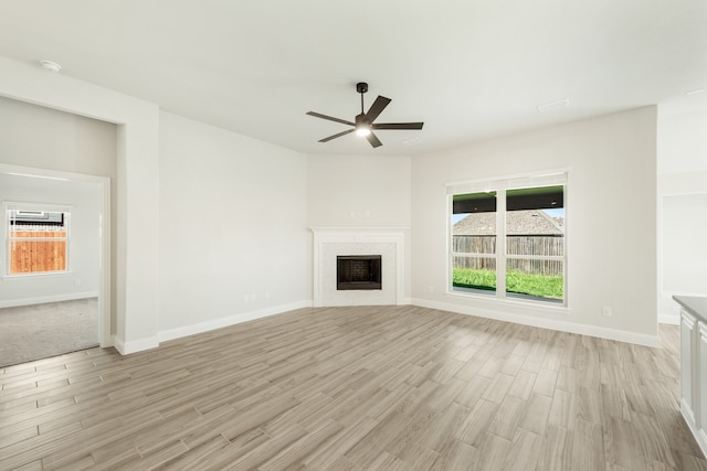 unfurnished living room with light wood-type flooring and ceiling fan