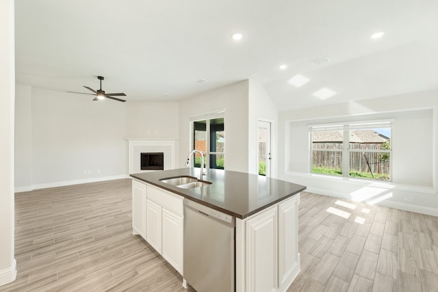 kitchen featuring vaulted ceiling, white cabinets, dishwasher, light hardwood / wood-style flooring, and sink