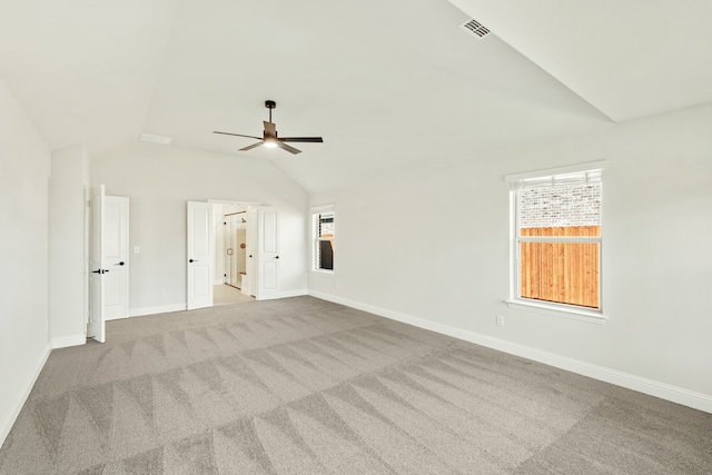 carpeted empty room with lofted ceiling and ceiling fan