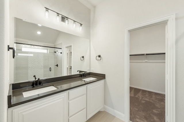 bathroom featuring vanity, lofted ceiling, and an enclosed shower