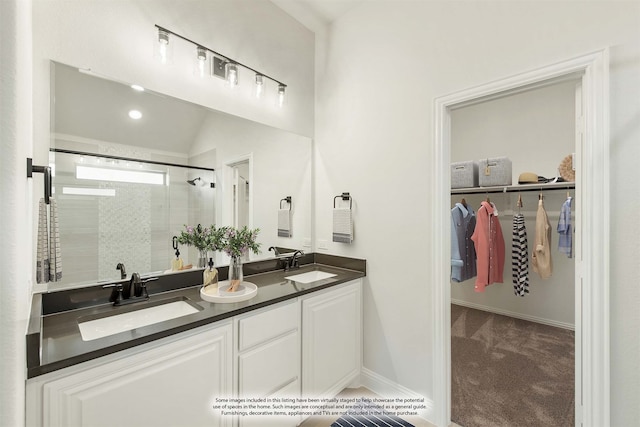 bathroom featuring vanity, vaulted ceiling, and an enclosed shower