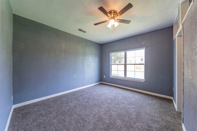 unfurnished room featuring carpet flooring, ceiling fan, and a textured ceiling