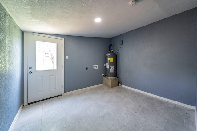 interior space featuring a textured ceiling, electric water heater, and lofted ceiling