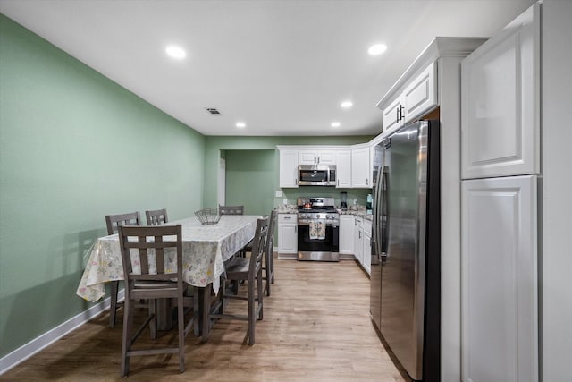 dining room with light hardwood / wood-style flooring