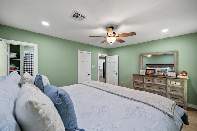 bedroom with ceiling fan and hardwood / wood-style floors