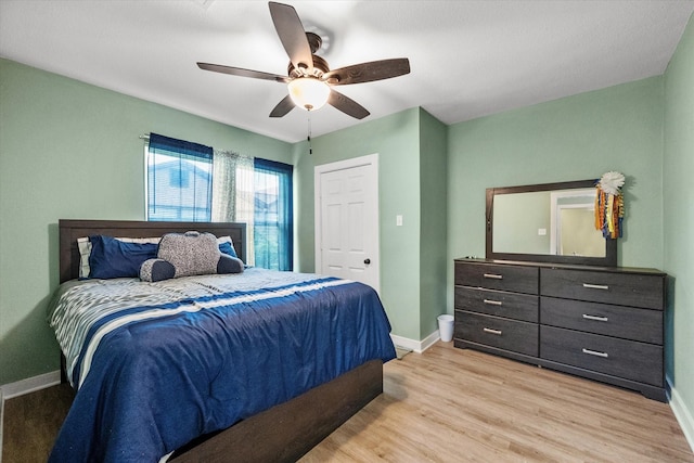 bedroom with ceiling fan and light hardwood / wood-style floors