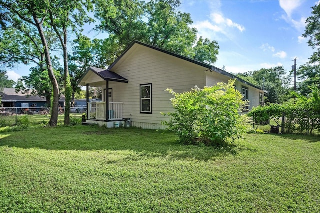 rear view of property featuring a lawn