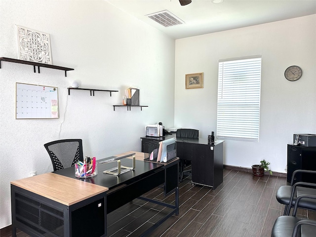 office space with baseboards, visible vents, ceiling fan, and wood finished floors