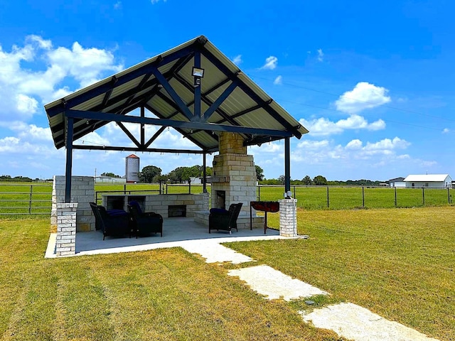 view of community with a yard, a patio area, fence, and a gazebo