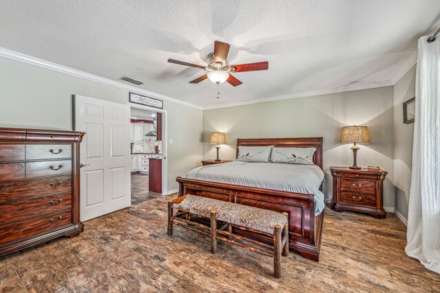 bedroom with a textured ceiling, ornamental molding, ceiling fan, and dark hardwood / wood-style flooring