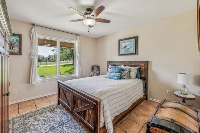 tiled bedroom featuring ceiling fan