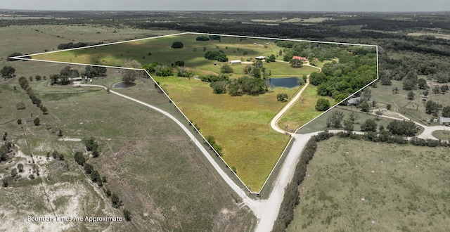 birds eye view of property featuring a rural view and a water view