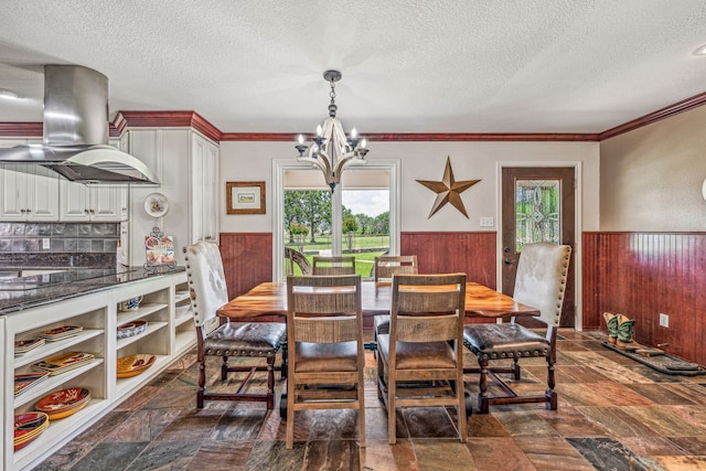 tiled dining area with crown molding, plenty of natural light, a textured ceiling, and a notable chandelier