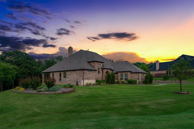 back house at dusk with a yard