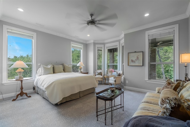 carpeted bedroom with ceiling fan and ornamental molding