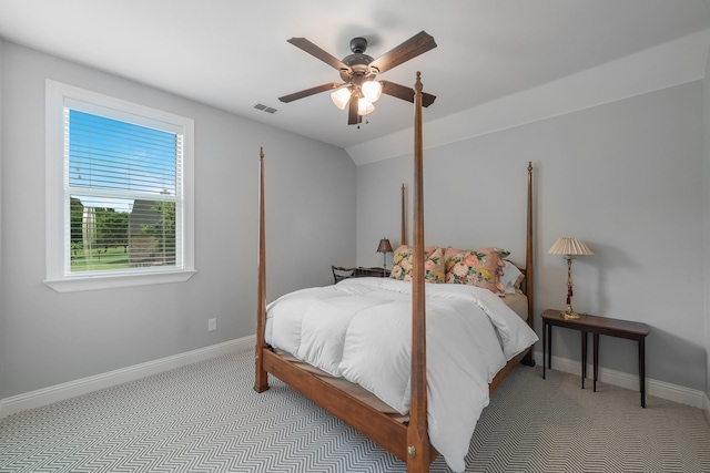 bedroom with ceiling fan, lofted ceiling, and light carpet