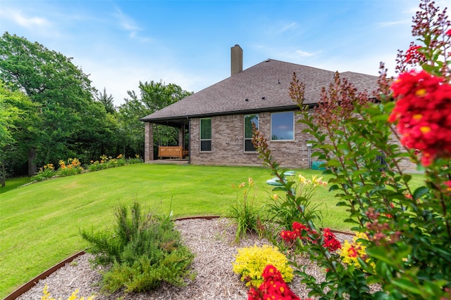 rear view of property with a yard