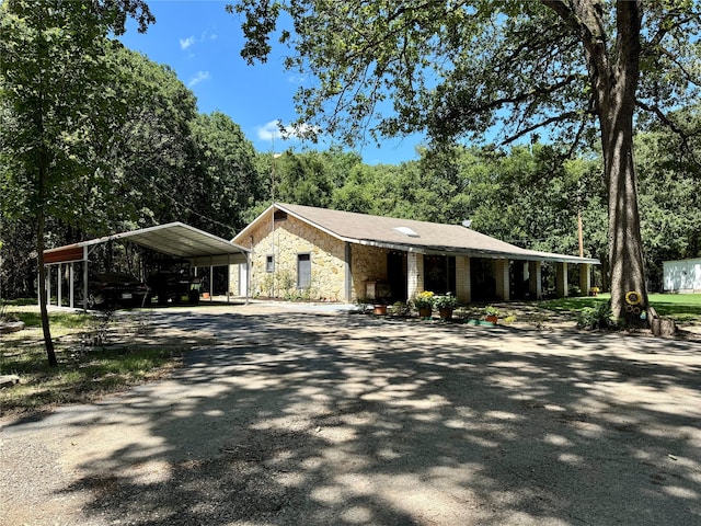 ranch-style house featuring a carport