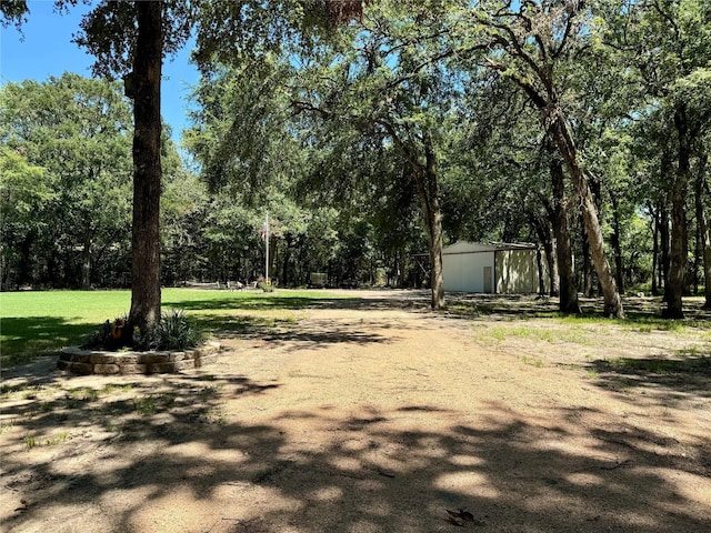 view of yard featuring a shed and an outdoor structure