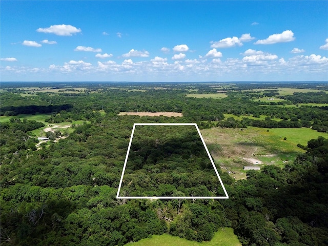 birds eye view of property with a wooded view