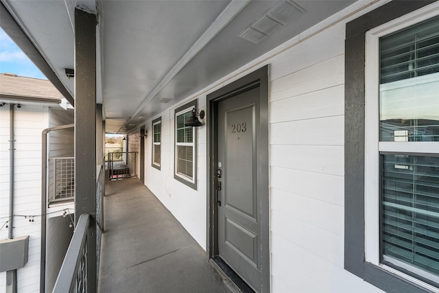 property entrance featuring visible vents and a porch