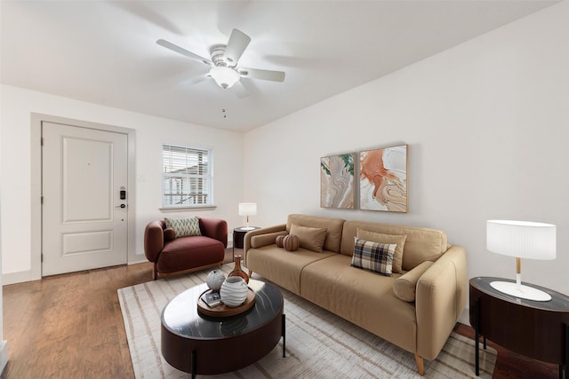 living room with light wood-type flooring and a ceiling fan