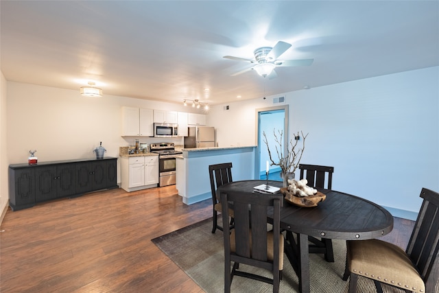 dining room with dark wood-type flooring and ceiling fan