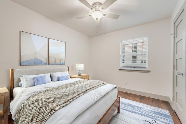 bedroom with ceiling fan, baseboards, and wood finished floors