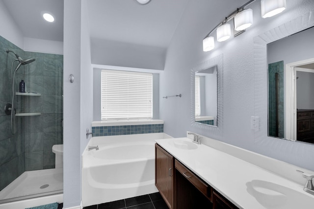 bathroom with plus walk in shower, vanity, and tile patterned flooring