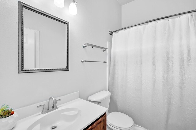 bathroom with toilet and vanity