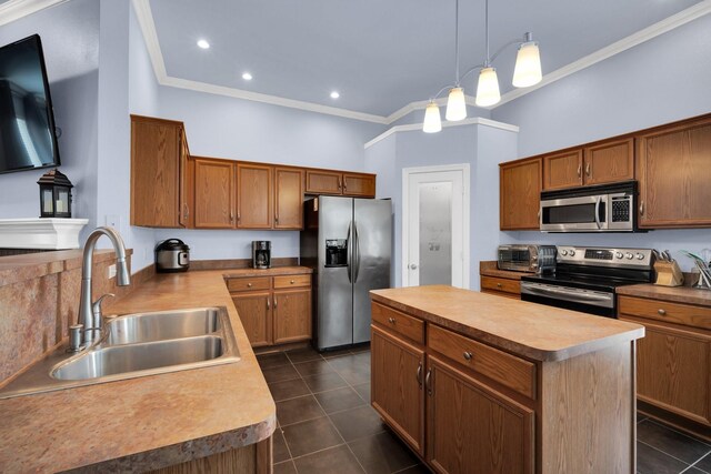 kitchen featuring pendant lighting, a center island, stainless steel appliances, sink, and crown molding